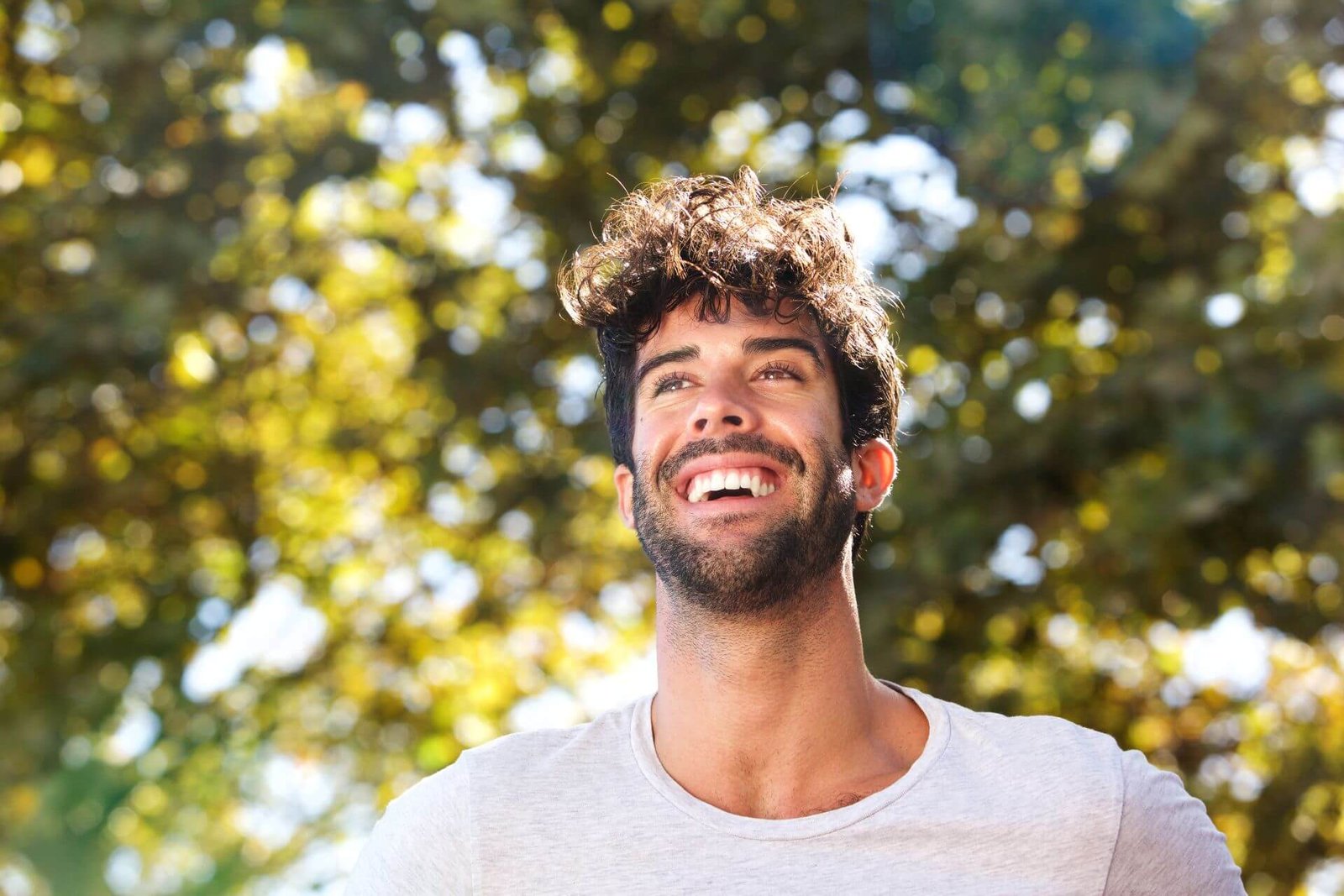 close-up-laughing-handsome-man-with-beard-outside-2024-10-16-03-52-28-utc.jpg